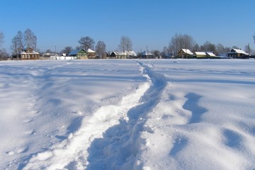 Trodden path in the snow to the village, Russia