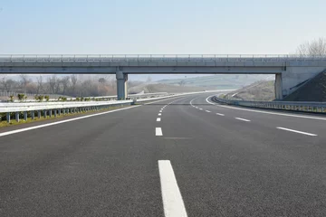 Foto op Plexiglas Construction of newly finished, empty highway. © ada