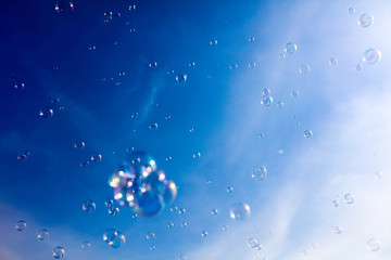 Fototapeta na wymiar Soap bubbles fly in the blue sky