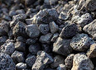 Stones on the edge of the asphalt road