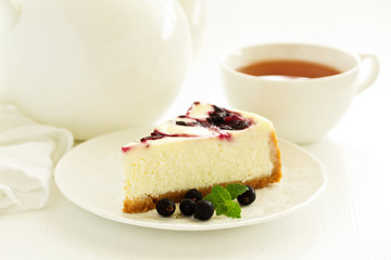 Homemade cheesecake with black currant jelly.