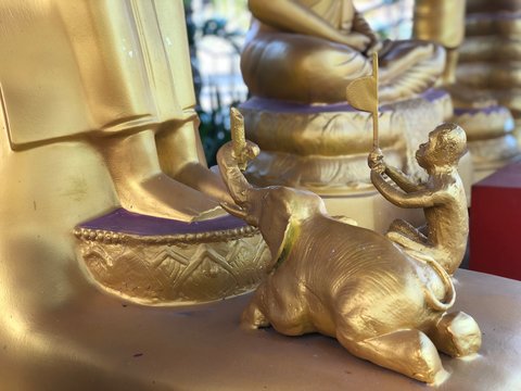 Golden monument in Thailand Phuket -monkey and elephant worship Buddha