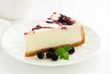 Homemade cheesecake with black currant jelly.