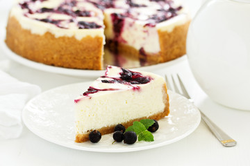 Homemade cheesecake with black currant jelly.
