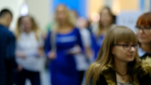 Visitors of a business conference walking at the hall
