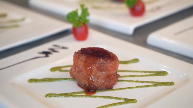 chef putting spring onions on fried chinese scallops ,slow motion
