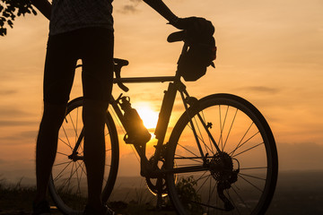 Fototapeta na wymiar silhouette cyclist at sunset time