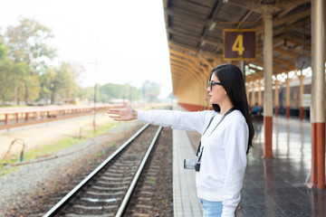 Happy ladies traveling at the train station Tourism concept