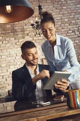 Happy couple using tablet
