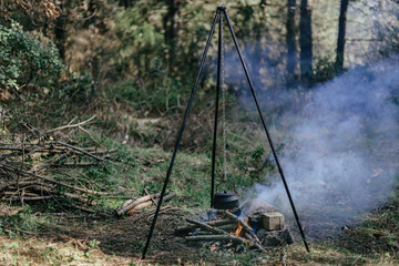 Pouring of tea from a thermos on a camping 