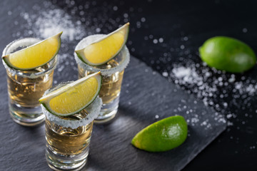 Three piles of mexican tequila with lime and salt 