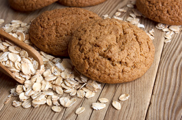 Oatmeal cookies with oat flakes with a wooden spoon. healthy food. on a wooden table