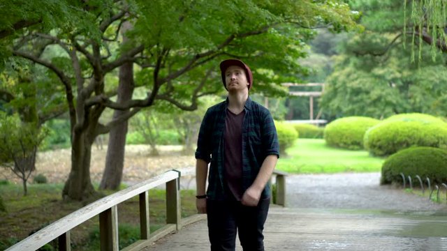 Caucasian Tourist Walking in Japanese Garden
