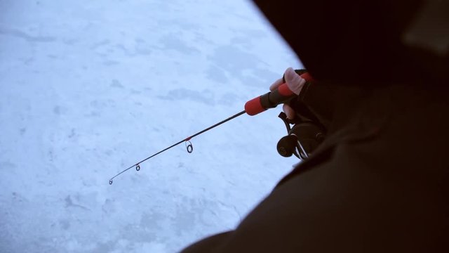 angler sticks with a short fishing rod and catches a zander