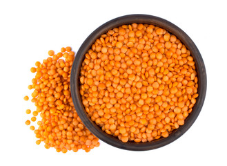 Red lentils in plate isolated on white background