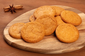 A closeup photo of ginger cookies with anise and cinnamon on rustic textures