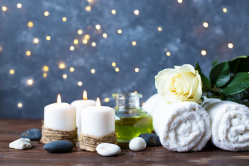 Spa, beauty treatment and wellness background Towel Cosmetic Massage oil, flowers, lights and candel