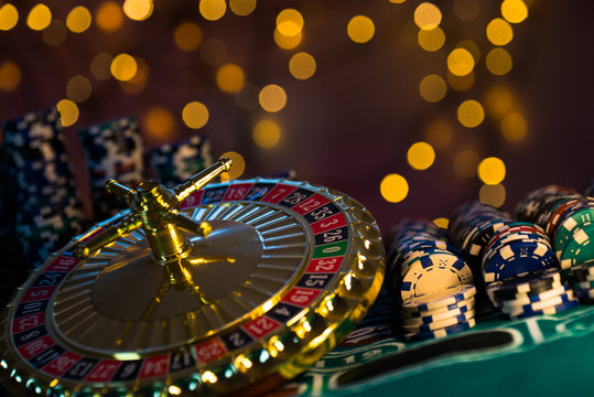 Casino theme. High contrast image of casino roulette, and poker chips