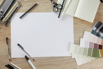 Collage view from above. View on top. Workspace artist or designer. paper on the wooden table. Template for a poster, postcards, ads. White blank sheet of paper. gamma: black, white, gray