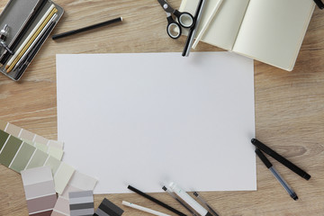 Collage view from above. View on top. Workspace artist or designer. paper on the wooden table. Template for a poster, postcards, ads. White blank sheet of paper. gamma: black, white, gray