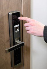Yong man or woman push fingers down the electronic control machine to access the door. Modern lock. scanning finger