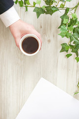 Business person's hand drinking coffee. コーヒーを飲んでいるビジネスパーソンの手