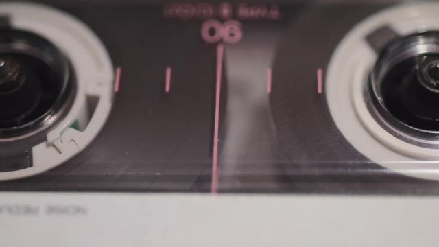 vintage tape cassette playing closeup footage with horizontal camera tracking