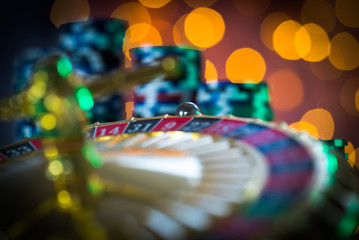 Casino theme. High contrast image of casino roulette, and poker chips