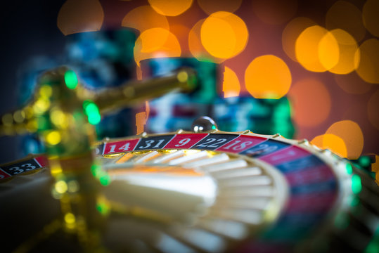 Casino theme. High contrast image of casino roulette, and poker chips