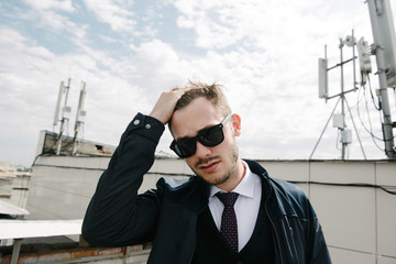 Man wearing suit and tie posing. Advertising menswear.