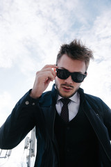 Man wearing suit and tie posing. Advertising menswear.