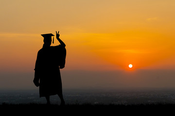 Fototapeta premium Silhouette education graduation student success learning concept at sunset.