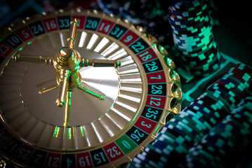 Casino theme. High contrast image of casino roulette, and poker chips