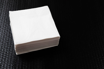 Paper napkin on black background.