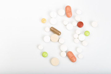 set of multi-colored tablets and capsules on a white background