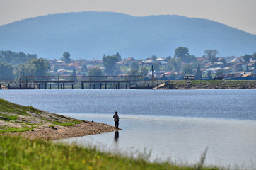 Fototapeta na wymiar The pond located near the village of Tirlyan (southern Urals) always attracts fishermen.