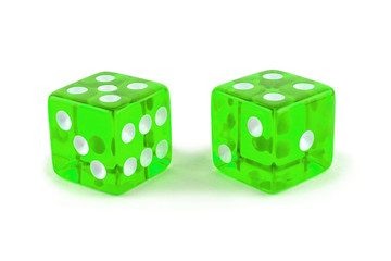Two green glass game dice very close up isolated on white background. Five and four with a shadow.