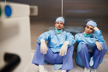 Two tired surgeon after the operation in the corridor