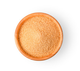 Brown refined sugar in wooden bowl on white background.
