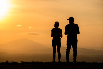 Fototapeta na wymiar Silhouette young couple on sunset time.