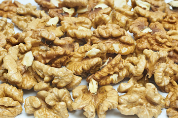 Walnuts on natural burlap, walnut kernels in a wicker basket, nutty background