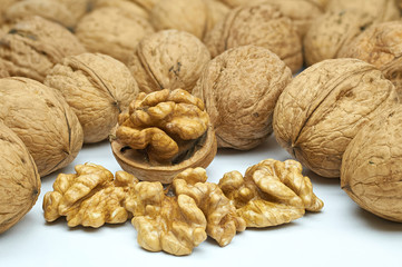 Walnuts on natural burlap, walnut kernels in a wicker basket, nutty background