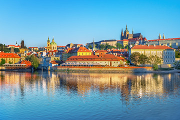 Fototapeta premium Scenic view Charles bridge and historical center of Prague, buildings and landmarks of old town at sunset, Prague, Czech Republic