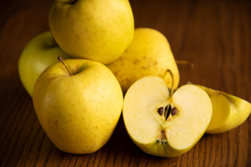 Yellow apple on the wooden vintage background