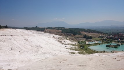 Charming Pamukkale pools in Turkey. Pamukkale contains hot springs and travertines, terraces of carbonate minerals left by running water. The world heritage site of UNESCO.