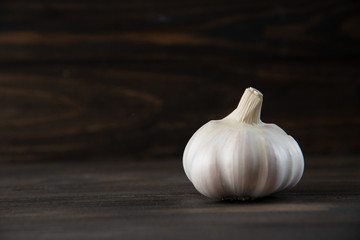 Garlic bulb on the wooden vintage background