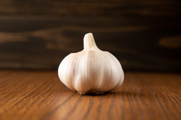 Garlic bulb on the wooden vintage background