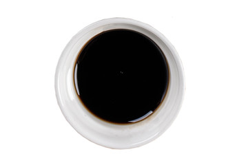 Soy sauce in a bowl on white background. One of the collection of various sauces.