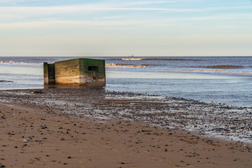 An old bunker on the beach of Newport, Norfolk, England, UK