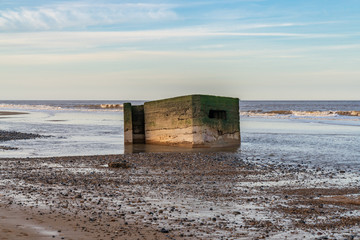 An old bunker on the beach of Newport, Norfolk, England, UK